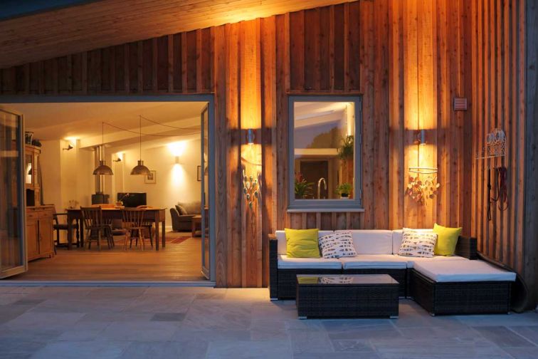 Wyches Barn. Exterior seating and patio at night